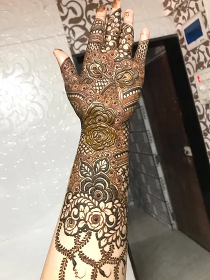 Another angle of the semi-bridal design, showing how the pattern flows from the fingers to the arm.
