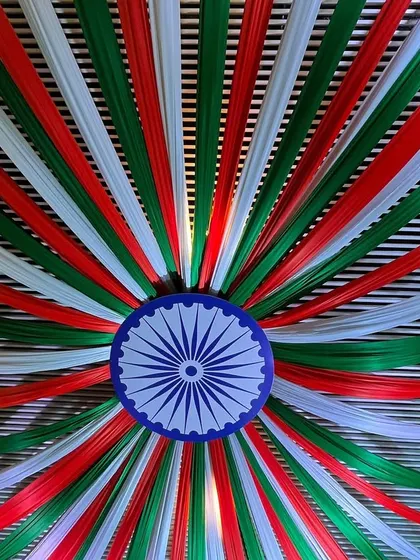 A stunning ceiling decoration for a national event. I used saffron, white, and green fabric strips to create a massive canopy radiating from a central Ashoka Chakra.