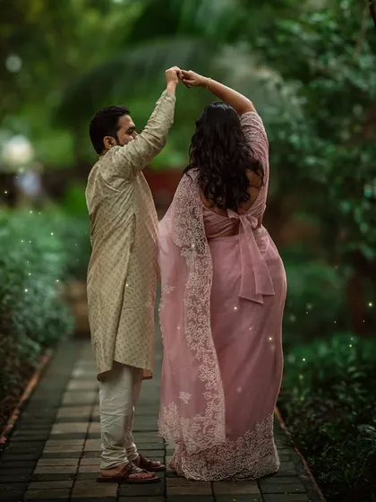 A spontaneous dance on a rain-soaked path, surrounded by lush greenery. This is the kind of magic I love to create during my outdoor maternity shoots, capturing the pure joy and romance of your journey together.