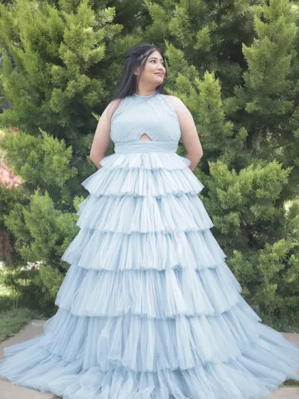 The bride-to-be looking like a princess in her tiered gown. The half-up, half-down hairstyle and soft makeup complete this enchanting pre-wedding look.