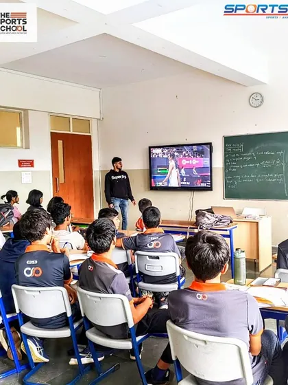 Students in a classroom analyze a sports match on screen, a session conducted in collaboration with SportsKPI to enhance their analytical skills.