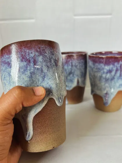 Holding one of the drip grip tumblers. The glaze has a beautiful, deep color that reminds me of a galaxy.