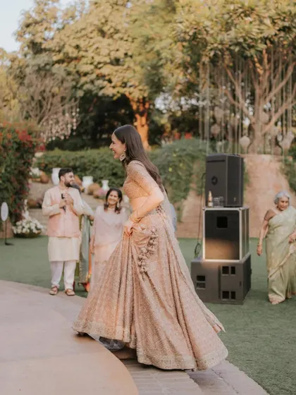 A bride's joyful entrance down the amphitheater steps, a perfect "bridal entry" moment during a daytime event.