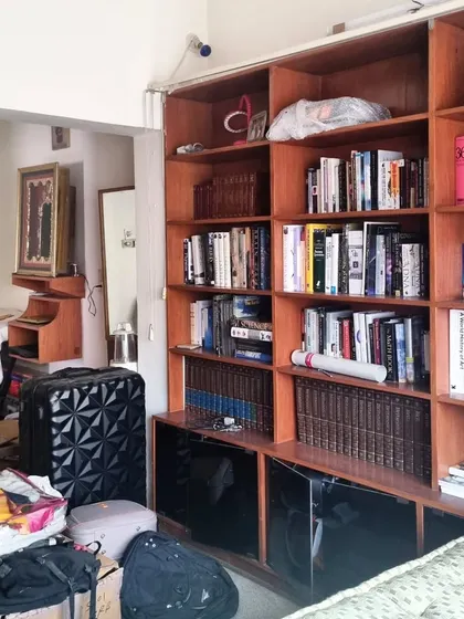 This before-and-after sequence shows how we reimagined a large, cluttered bedroom. By introducing a sliding partition and custom joinery, we created a multi-functional master suite with a cozy sleeping area, a wardrobe, and a bright study space, optimizing every inch of the room.