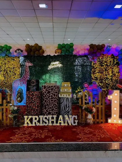 Welcome to the jungle! This safari-themed birthday party stage shows how I layer different textures, from a green foliage wall and sequin panels to animal-print pedestals. The light-up marquee number and custom name sign make it a personalized adventure.