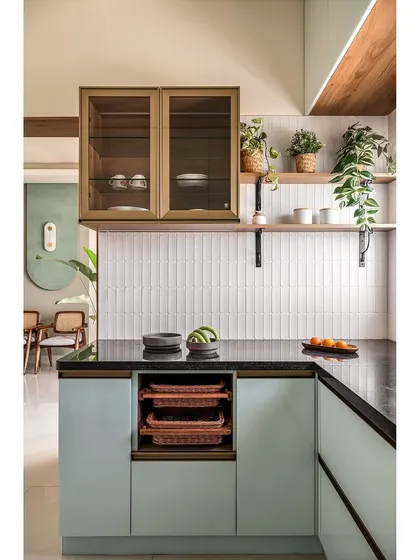 For 'The Boho Escape', I designed this U-shaped kitchen in a soothing pastel blue acrylic finish. The layout maximizes storage and counter space in a compact area, with open shelves for plants and decor.