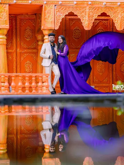 The reflection in the water perfectly captures the rich purple gown and the ornate orange architecture. This is a great example of using the location's features to create a unique and artistic shot.