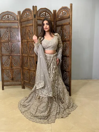This grey lehenga with heavy silver embroidery is a sophisticated and modern choice for any party.