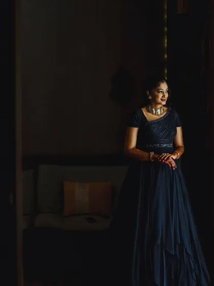 A moody and elegant shot of the blue georgette gown. The soft rushing on the bodice and the flowing skirt create a graceful silhouette, perfect for an evening celebration.