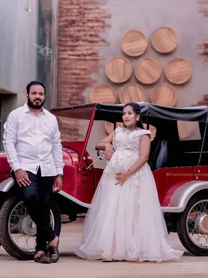 Another shot from the vintage-themed maternity session. The couple poses with a classic car, and the white gown I provided adds a touch of timeless elegance.
