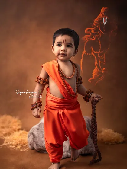 Another powerful portrait of a child as Rama, with a graphic of the deity in the background. The determined expression and confident pose make this a striking image that families love.