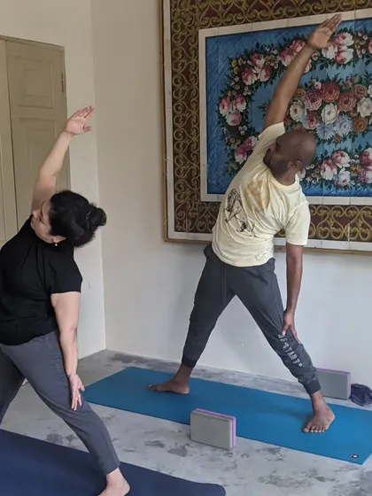 Beautiful memories from a yoga retreat. Here, students are practicing side angle and triangle poses, finding alignment and joy together.