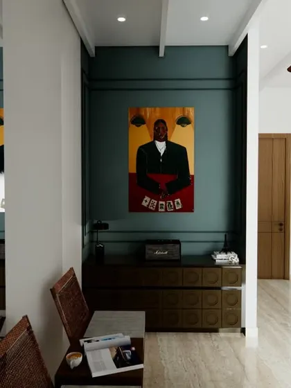 A glimpse into a hallway from Project Yūgen, where bold art and a deep teal accent wall create a dramatic and stylish passage. The design uses mirrors to enhance the sense of space and light.