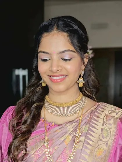 A close-up of Shriya's makeup for her first baby shower look, featuring soft shimmery eyes and a natural lip.