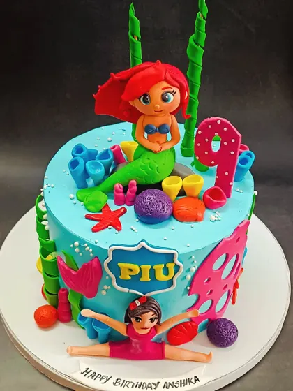 This Little Mermaid cake combines two passions: Disney and gymnastics! It features a handcrafted Ariel and a gymnast topper.