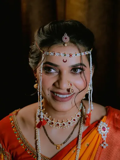A stunning close-up of a Maharashtrian bride, focusing on her expressive eyes and traditional jewelry.
