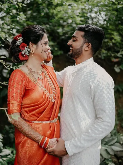 A candid moment of interaction between the couple. The natural setting and their happy expressions create a beautiful, relaxed portrait.