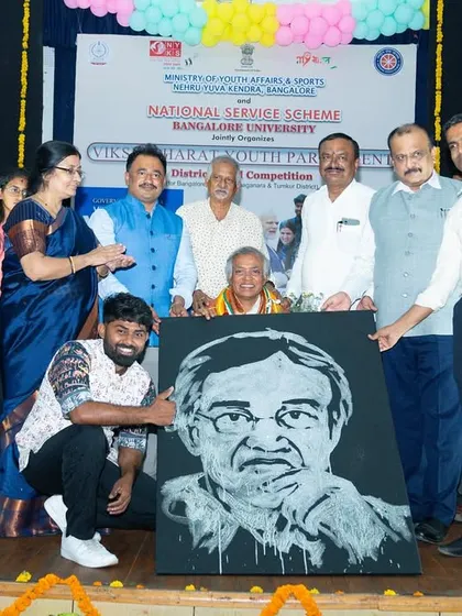 Presenting the finished portrait of the Bangalore University Vice-Chancellor at the India Youth Parliament event. Live art is a powerful way to commemorate an event and honor special guests.
