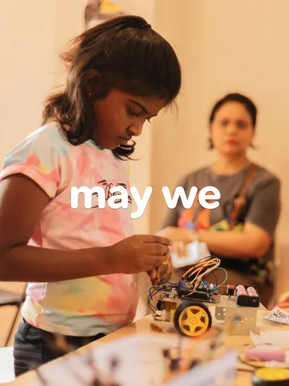 A young female engineer focuses on her robotics project, breaking stereotypes and building the future. Happy Women's Day.