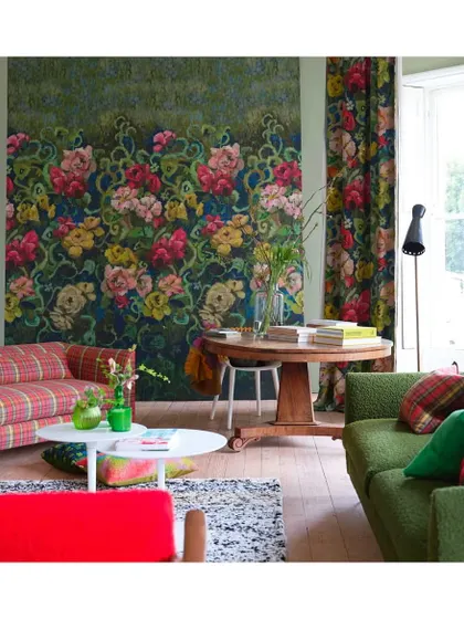 A large-scale chromatic floral print can add elegance, depth, and a refreshing focal point to any space. This Tapestry Floral Wallpaper by Designers Guild showcases how bold blooms can be paired with eclectic furnishings for a look that is both vibrant and timeless.