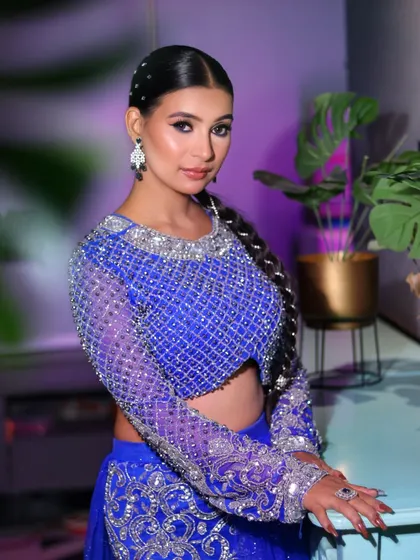 Slaying in royal blue. This glamorous look features soft, neutral makeup that lets the stunning, heavily embellished outfit shine.