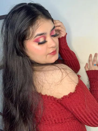 A side profile showing the winged shape of the red eyeshadow.