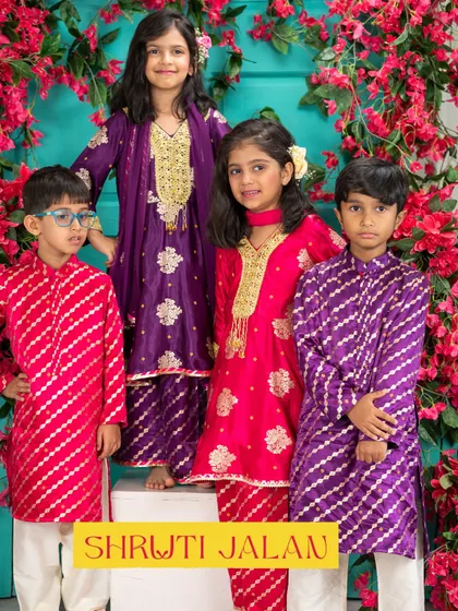 Rakhi is a celebration of sibling love, and I design my outfits to match that spirit. Here are two sibling pairs in coordinated festive colors, featuring a pink and purple theme with rich embroidery and comfortable fabrics.