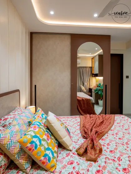 The sliding wardrobe in this room features an arched mirror, adding both functionality and a design element.