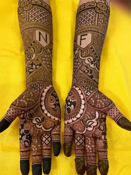 A bold and beautiful bridal design incorporating the couple's initials in stylish shields. This is for the bride who wants to make a statement with her mehndi.