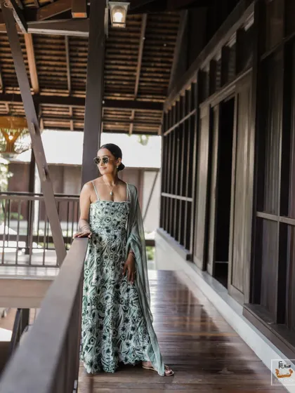 The bride posing on the balcony of her villa at The Palayana, Thailand.
