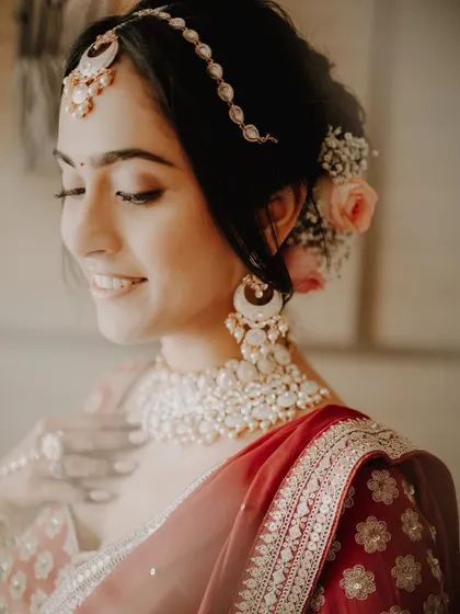 A simple and beautiful portrait of a bride, her makeup and jewelry highlighted by the soft, natural light.