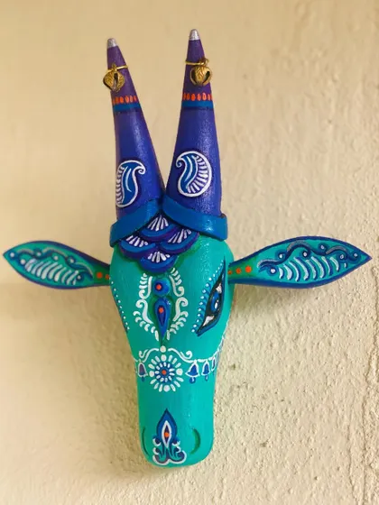 This teal Nandi features beautiful white paisley and floral motifs, giving it a serene and elegant feel.