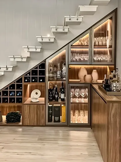 I made the most of this space by designing a custom bar and crockery unit under the staircase. The design includes a wine rack, glass-fronted cabinets with internal lighting, and plenty of storage.