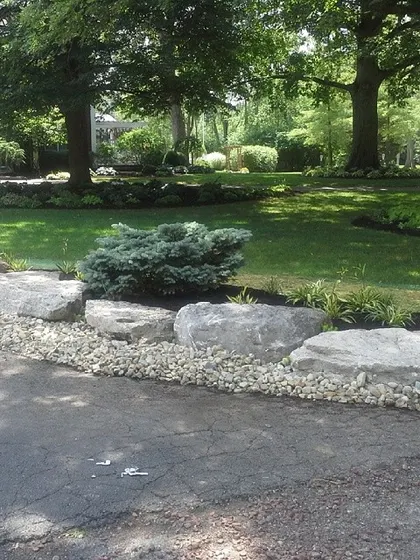 Sometimes it’s the details along the driveway that make a big difference. I used these large boulders and river rock to create a solid, low-maintenance border that adds a lot of character.
