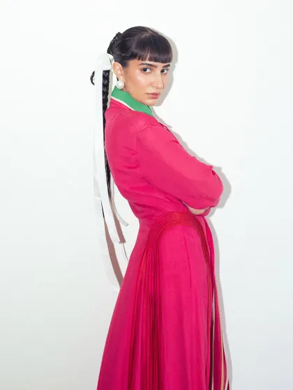 A final pose in the vibrant pink Bodice dress, showcasing a confident and colorful personal style.