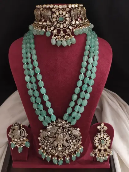 This unique Victorian set in pastel green features elephant and Krishna motifs in the metalwork. It's a perfect fusion of modern colors and traditional Indian designs.