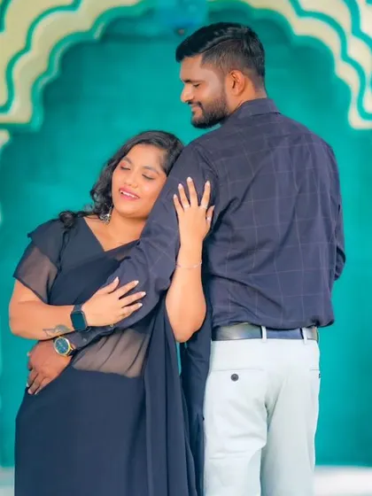 An intimate pre-wedding photo in a vibrant blue and white corridor. The architecture and colors make for a unique and artistic backdrop.