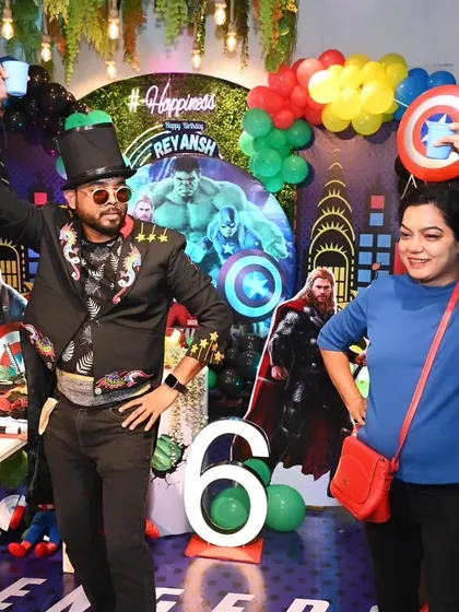 Sharing a fun, energetic moment on stage with a guest at a superhero themed party. My goal is to spread happiness and get everyone laughing and dancing.