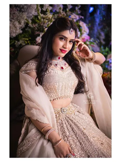 Mahima looking radiant for her engagement. The makeup is flawless and glowing, designed to look perfect under the evening lights of her celebration.