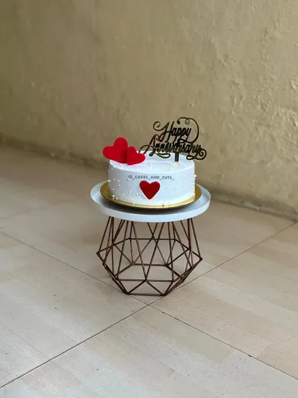 This anniversary cake uses bold red hearts to express love. We show you how to create simple fondant decorations that make a big impact.