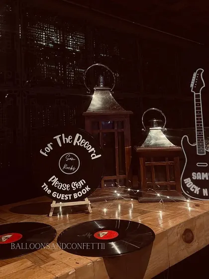For the record, please sign the guest book. I used vinyl records and a guitar cutout as part of the themed decor for this music-lover's party.