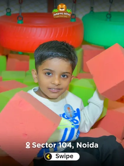 A young boy playing in our foam block pit. This area is perfect for soft landings and creative building.