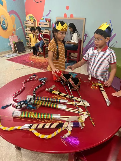 Children checking out the handmade props for the Ramleela. We create our own bows, arrows, and crowns, making the experience even more special.