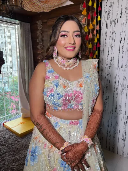 A vibrant and colorful look for a pre-wedding event. The makeup is bright and fun, with a focus on pink tones.