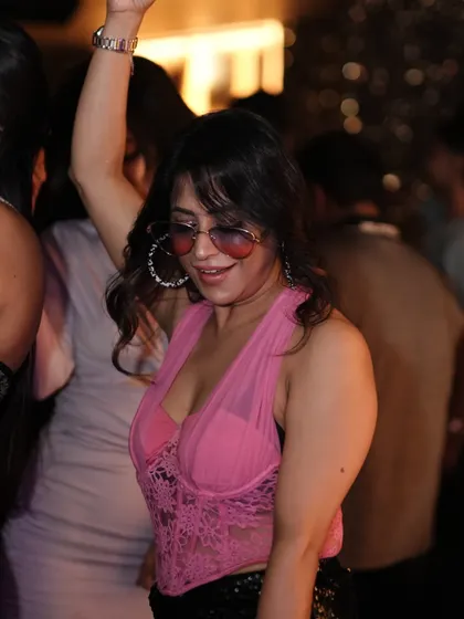 A guest in a pink top dancing and enjoying the music. The crowd at Kaze always brings great energy.