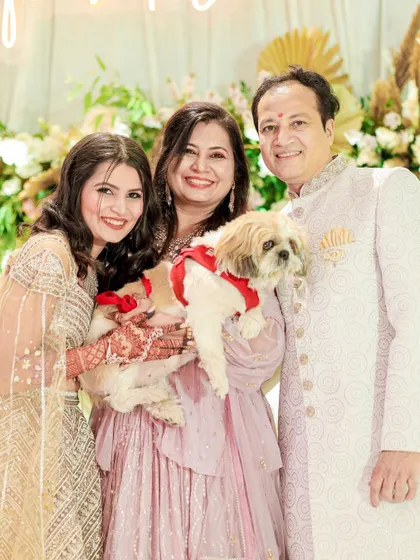 A happy family portrait, including the furry family member! Bhoomi looks radiant and happy with her loved ones.