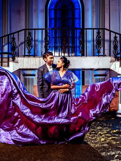 The metallic sheen of this purple gown with its long trail creates a beautiful, ethereal effect, perfect for a romantic and dramatic pre-wedding photo.