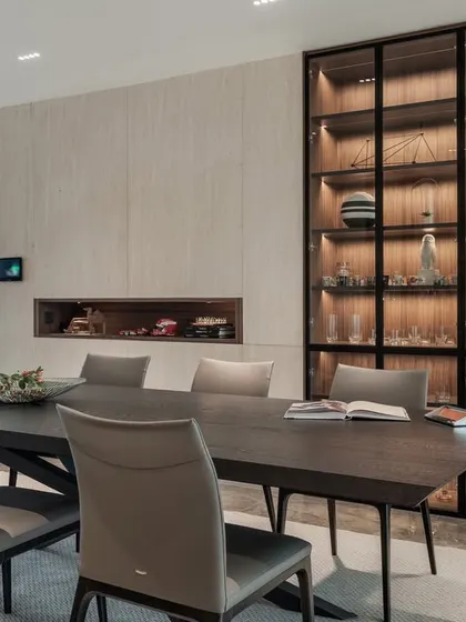 The formal dining area features a stunning, back-lit cutlery cabinet that serves as both storage and a piece of art. It reflects my philosophy of integrating beauty into the functional aspects of a home.