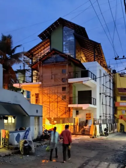 Here is the Earthen Spirit building during the final stages of its transformation, seen at dusk. The new upper levels are illuminated from within, highlighting the new architectural form we added to the original structure. This view captures the transition from a forgotten warehouse to a beacon of the neighborhood.