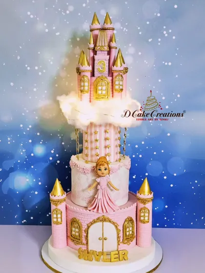 A detailed front view of the princess castle cake, highlighting the gold-tipped turrets, the starry middle tier, and the grand entrance.